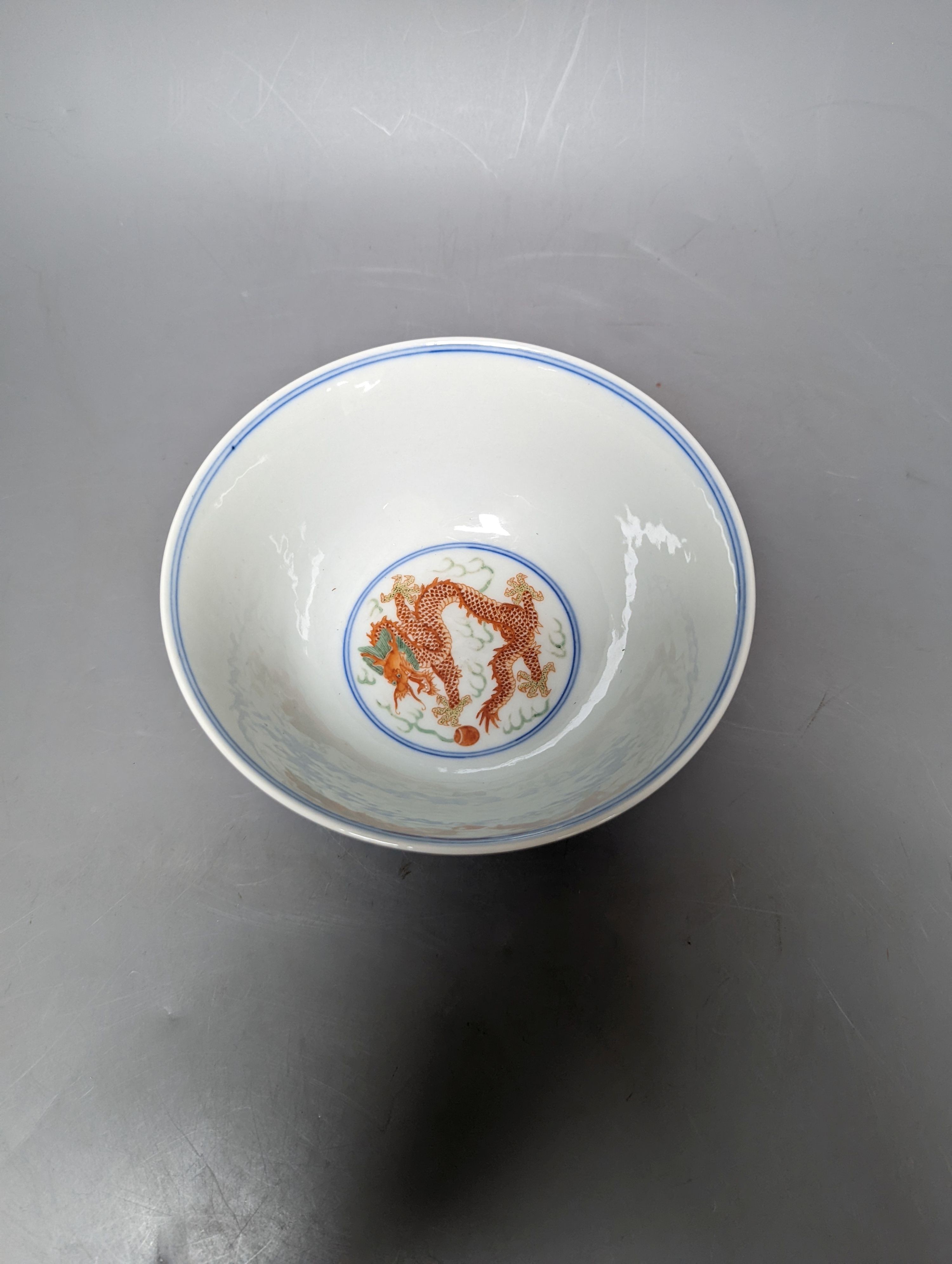 A Wucai bowl, dragon and flamingo pearl decoration, Jiaqing mark, on wood stand. 16cm diameter